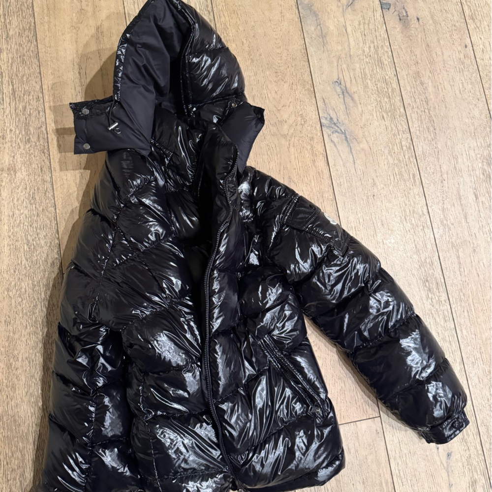 Brand new Monclair jacket with hoodie. Unisex. New condition and shiny black.